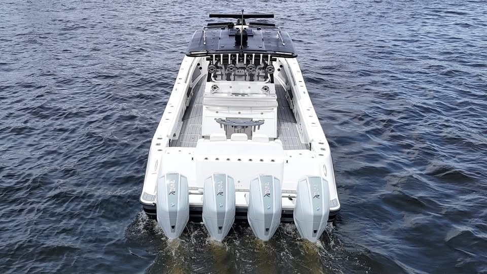 Center console boat running with four outboard engines
