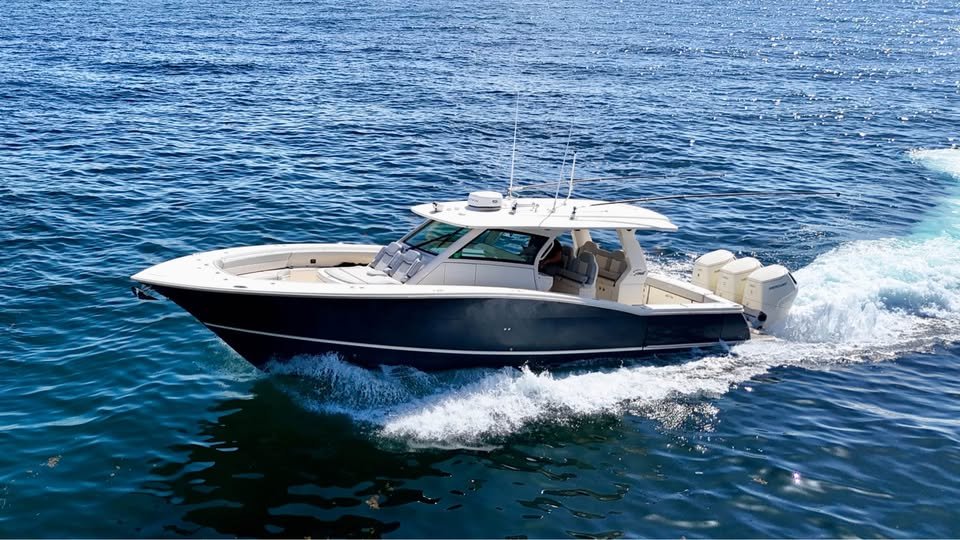 Sport and express cruiser under way on open water